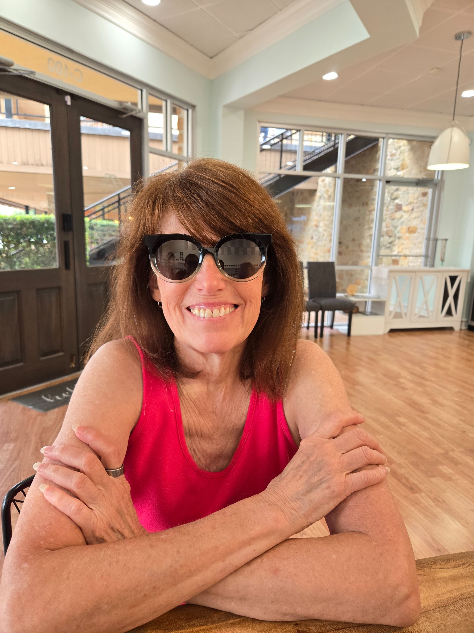 Smiling Bright Side Optical client wearing black sunglasses