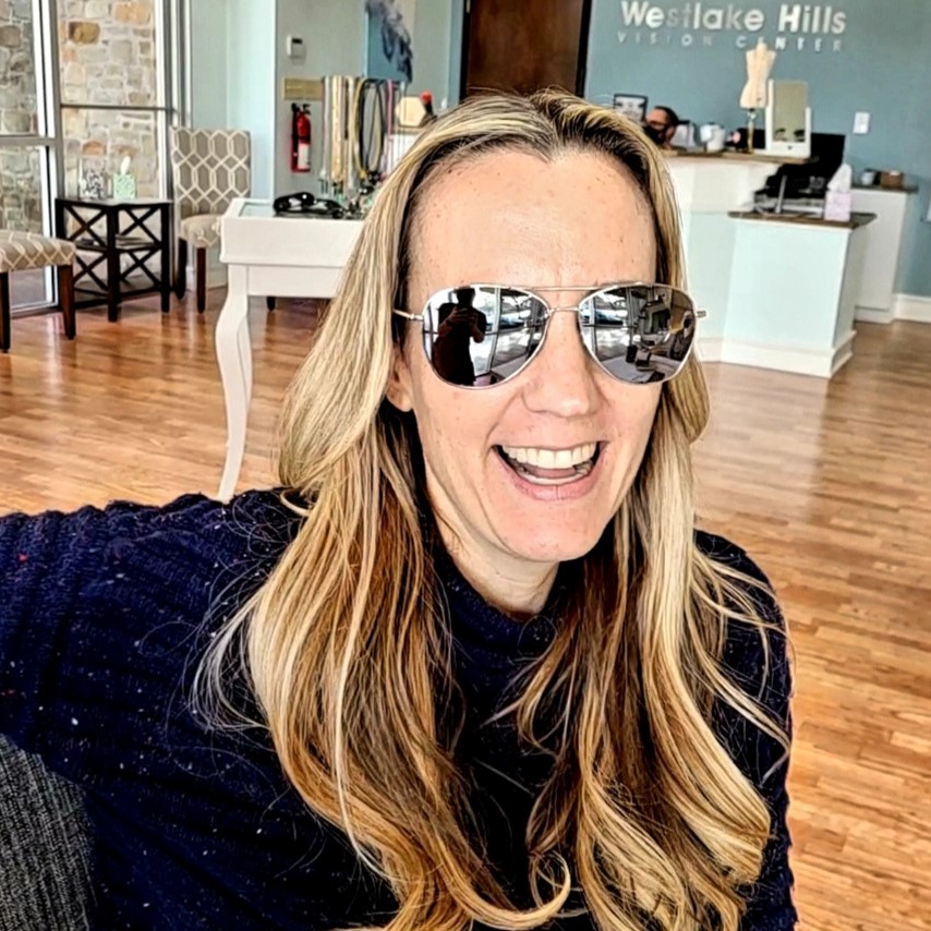Smiling Bright Side Optical client wearing mirrored sunglasses