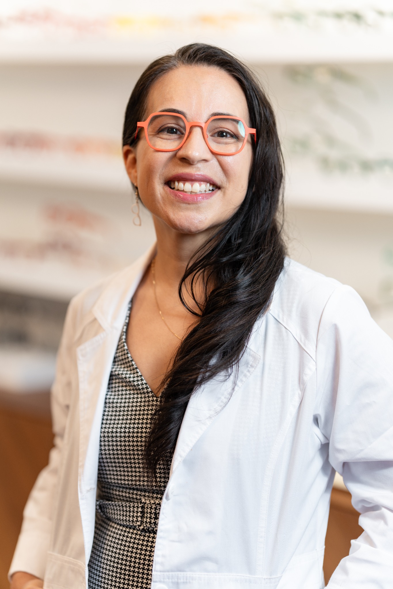 Dr. Susan Elizondo wearing coral glasses